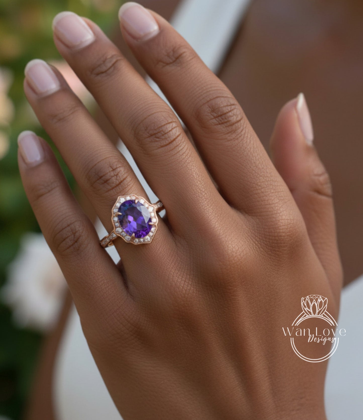 A close-up of a person's hand wearing a gold ring with a large purple gemstone.