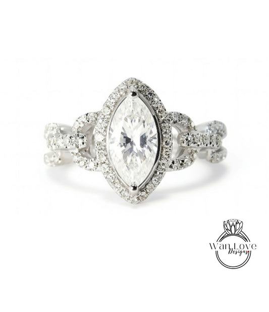 A close-up of a diamond engagement ring with a large central diamond surrounded by smaller diamonds and a halo of smaller diamonds around the center stone.