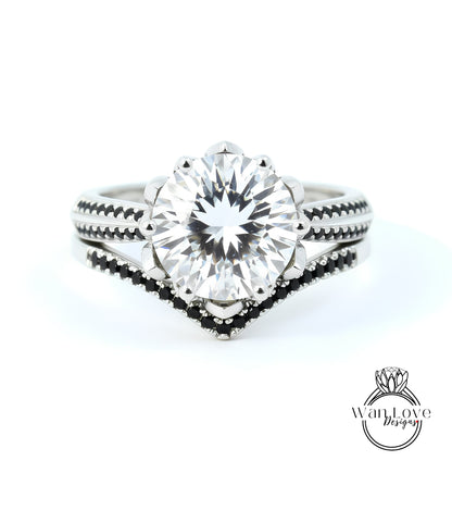A close-up view of a diamond engagement ring with a large central diamond surrounded by smaller diamonds on either side, set in a silver band with black accents.