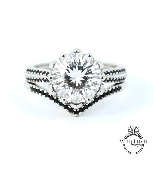 A close-up view of a diamond engagement ring with a large central diamond surrounded by smaller diamonds on either side, set in a silver band with black accents.