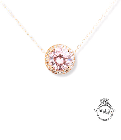 A necklace with a large, round, pink gemstone at the center, surrounded by a halo of smaller diamonds.