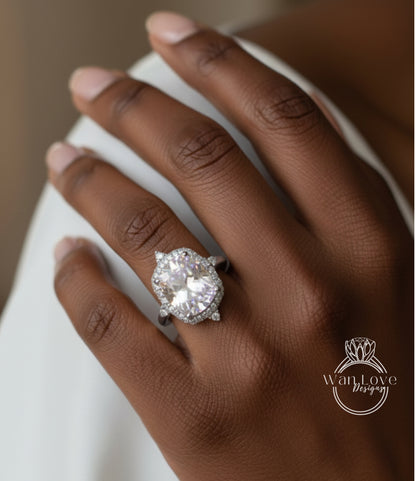 A close-up of a person's hand wearing a large, sparkling diamond engagement ring.