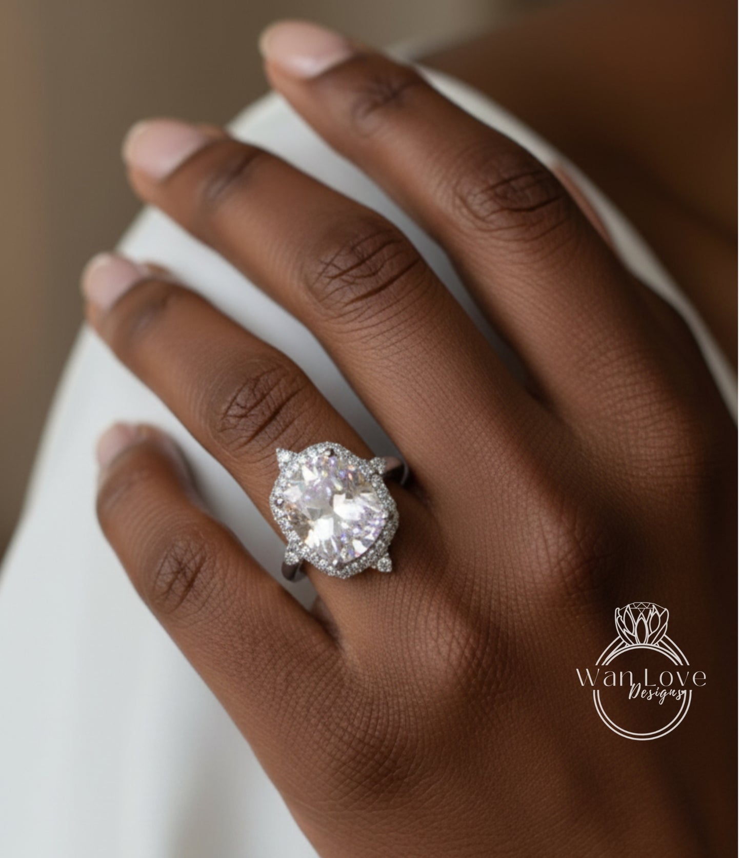 A close-up of a person's hand wearing a large, sparkling diamond engagement ring.
