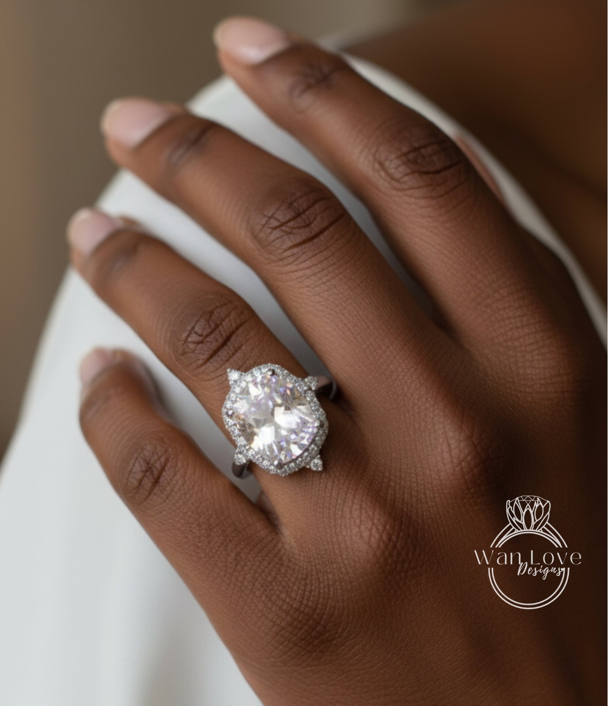 A close-up of a person's hand wearing a large, sparkling diamond engagement ring.