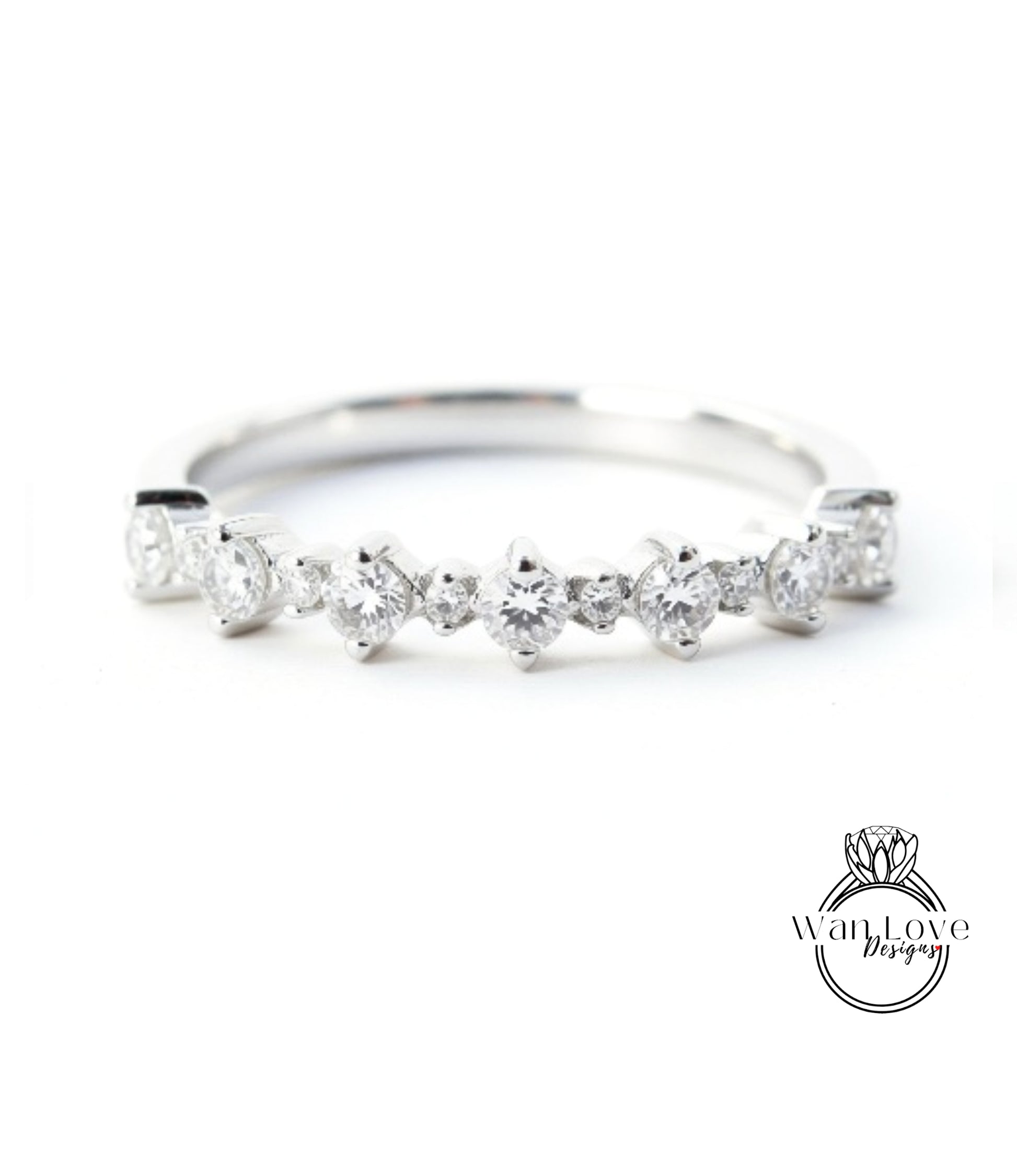 A silver ring with a row of small diamonds set in the band.