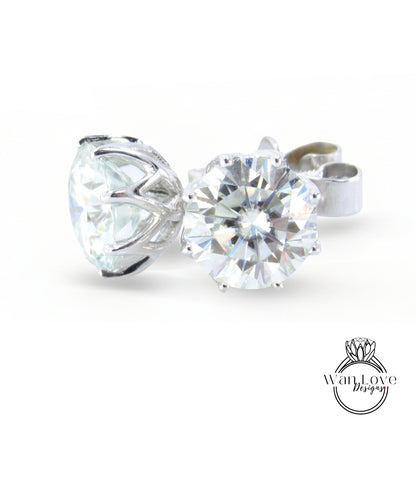 A close-up image of a large, clear diamond set in a silver earring.