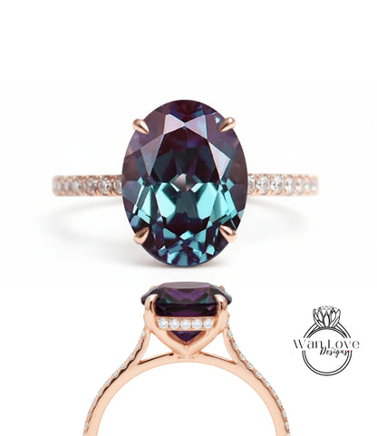a large, oval-shaped gemstone ring with a gold band and small diamonds.