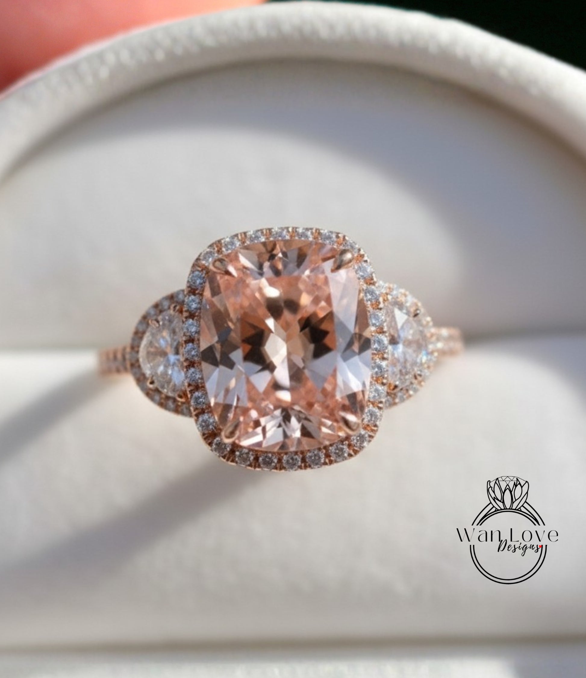 A close-up image of a beautiful engagement ring with a large, oval-shaped pink gemstone surrounded by smaller diamonds.
