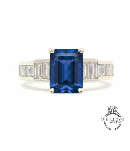 A ring featuring a large blue gemstone, possibly a sapphire, surrounded by smaller diamonds.