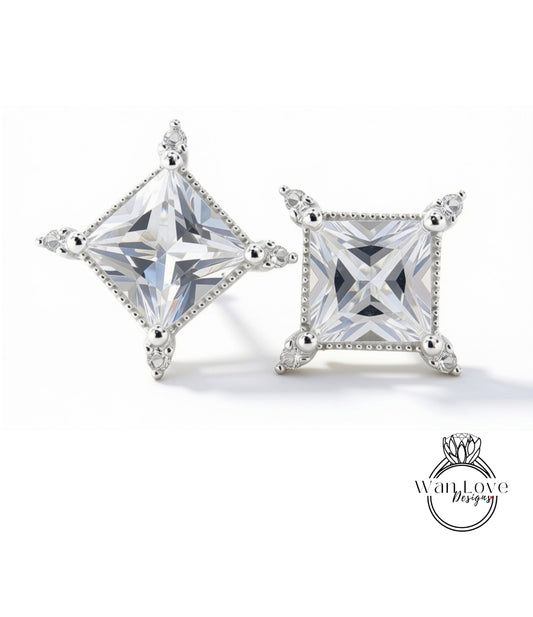 two diamond earrings with clear gemstones set in a square-shaped design, showcasing their intricate details and craftsmanship.