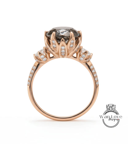 A rose gold engagement ring with a large central gemstone surrounded by smaller gemstones and a delicate floral design.