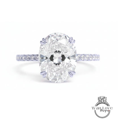 A close-up of a diamond engagement ring with a large oval-shaped diamond set in a band of smaller diamonds.