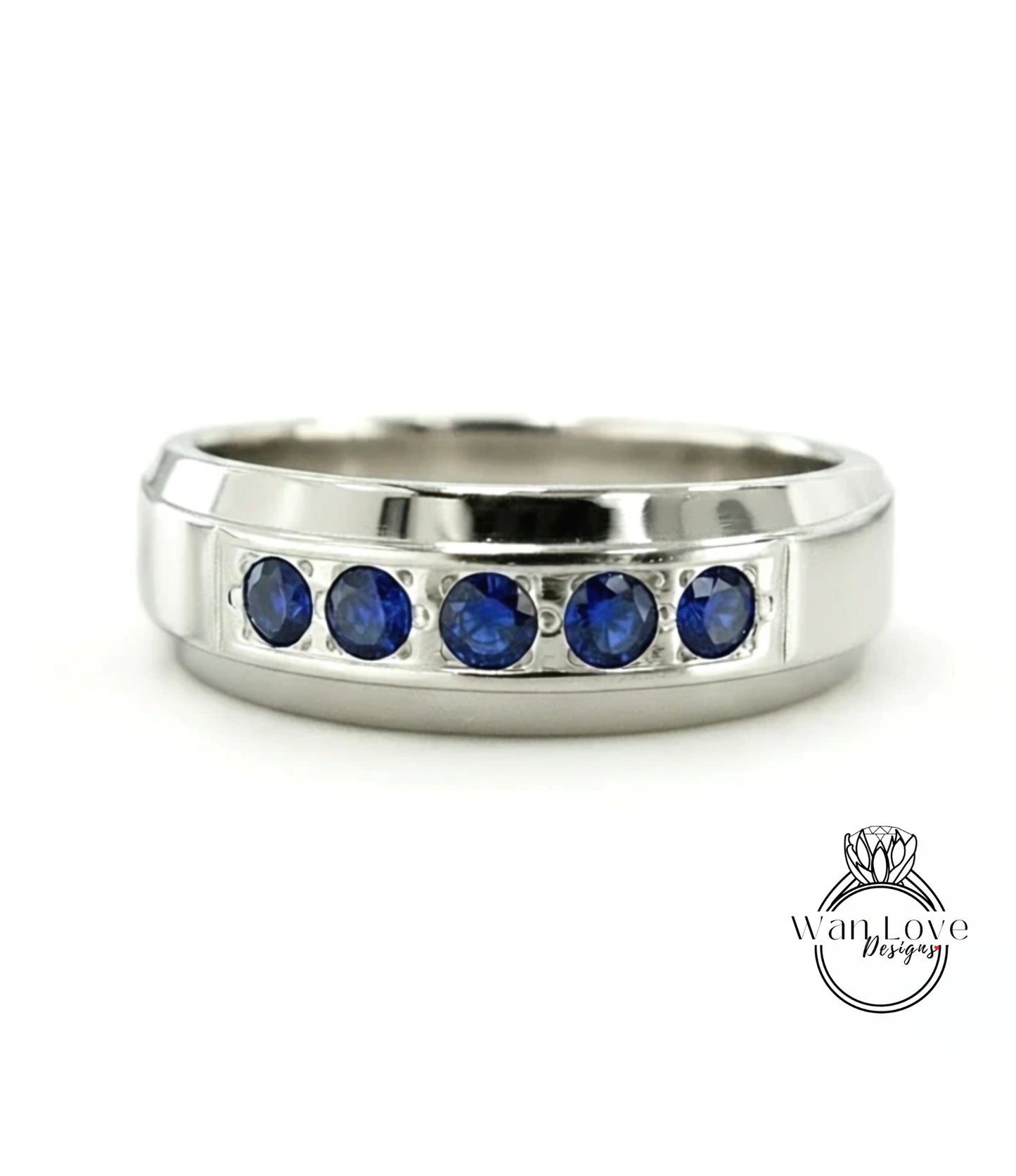 A silver ring with a row of blue sapphires set in the band.