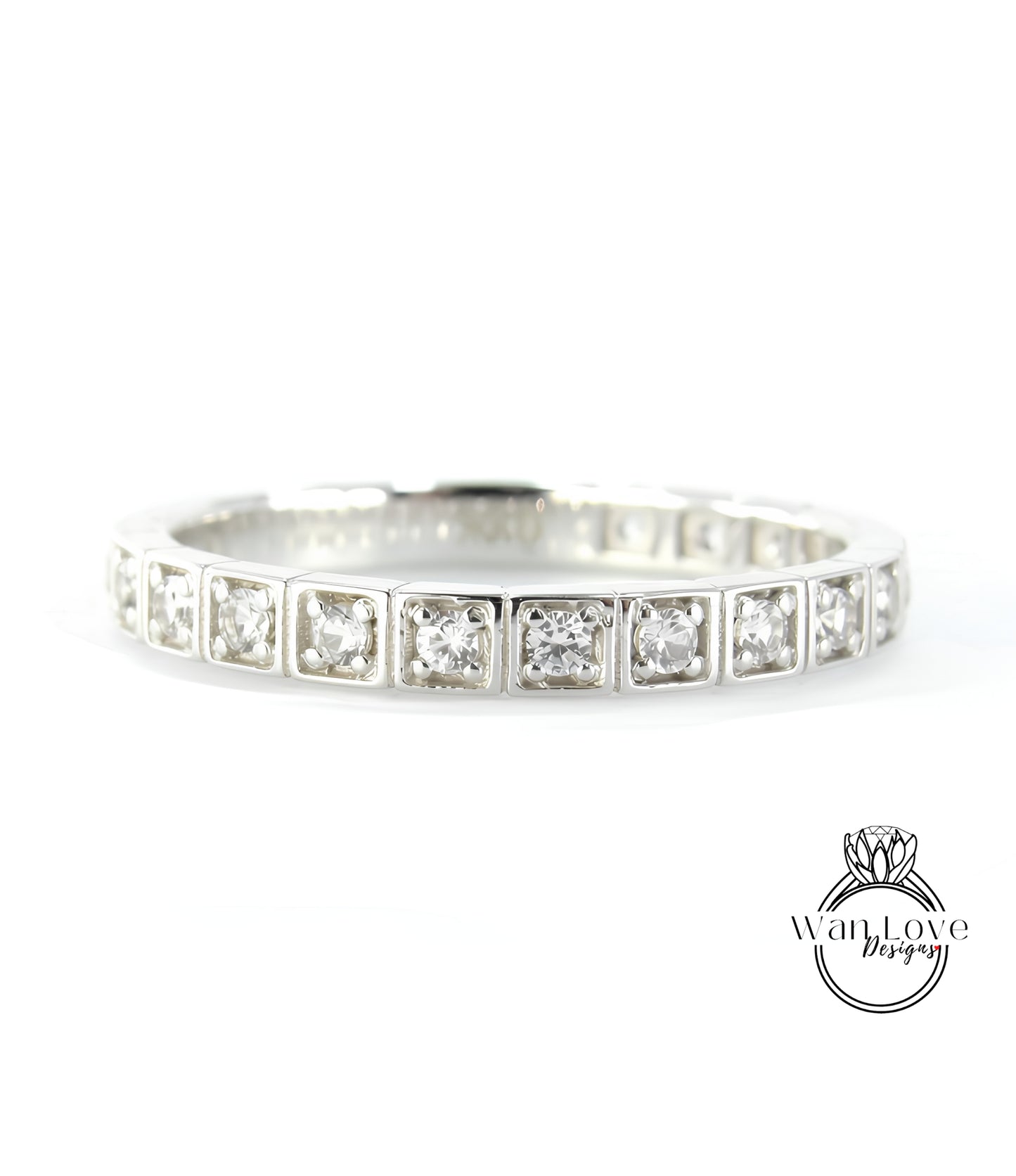 A silver band ring with a row of small diamonds set in the center.