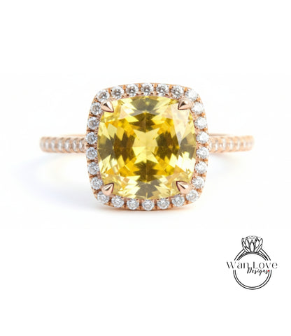 A large yellow gemstone ring with a halo of smaller diamonds around the center stone.