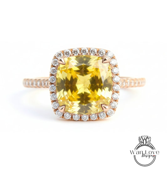 A large yellow gemstone ring with a halo of smaller diamonds around the center stone.