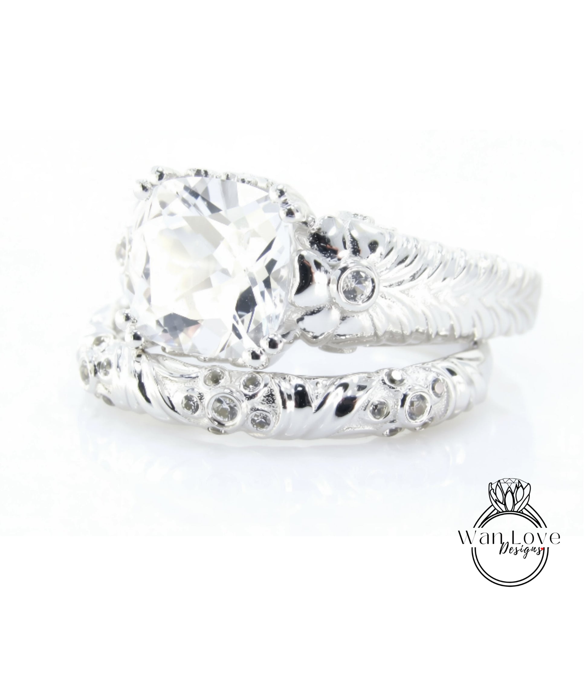 A close-up view of a large, clear gemstone set in a silver ring with intricate designs.