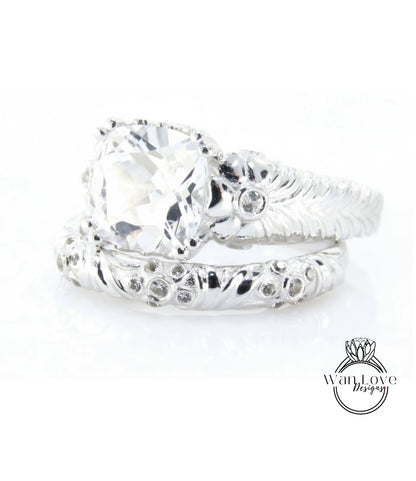 A close-up view of a large, clear gemstone set in a silver ring with intricate designs.