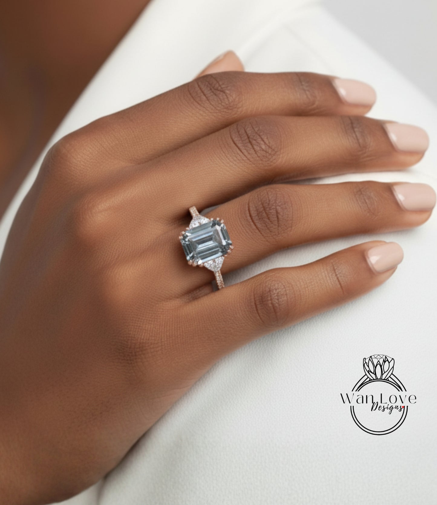 A close-up of a hand wearing a large, blue gemstone ring with a diamond accent.