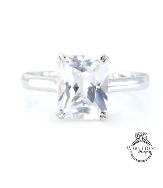 A close-up view of a diamond engagement ring with a large, clear gemstone set in a silver band.