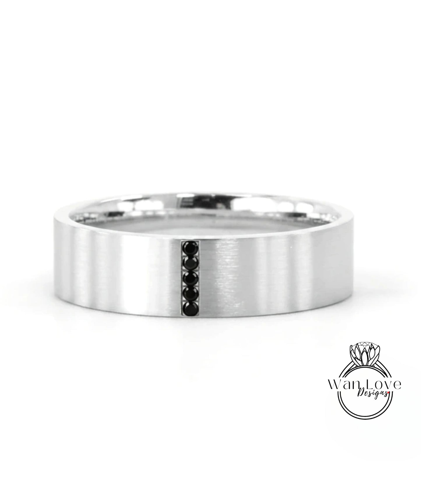 A silver-colored ring with a vertical black gemstone in the center.