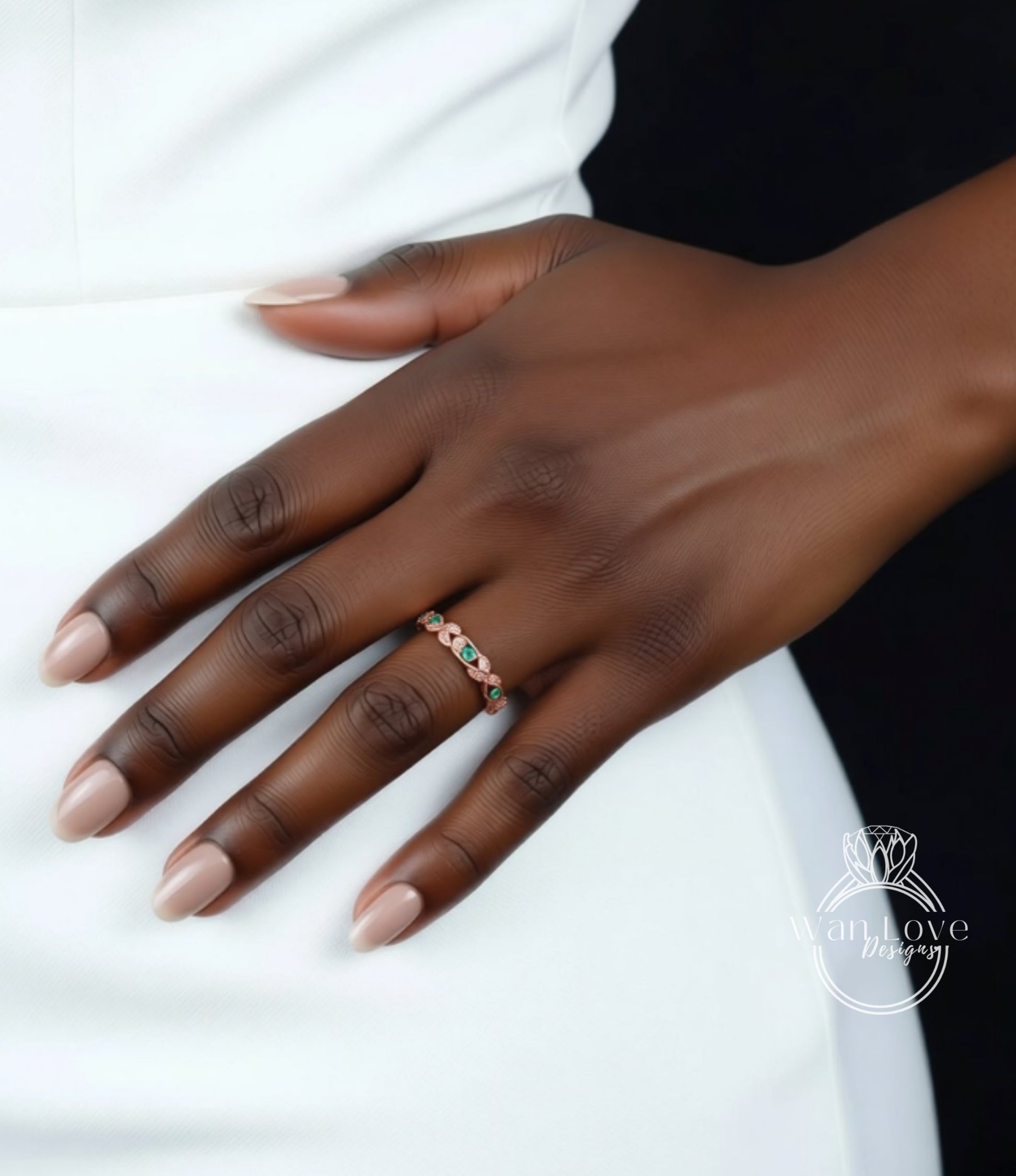 A close-up of a hand wearing a ring with a colorful gemstone set in a ring band.