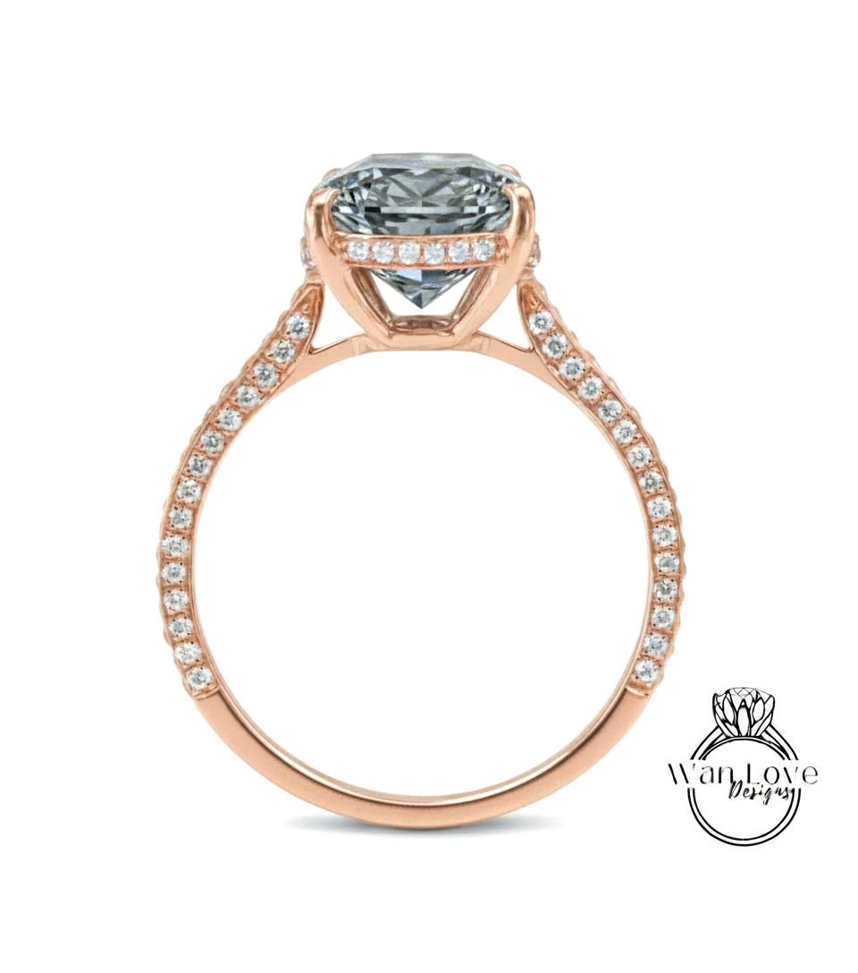 A rose gold engagement ring with a large, clear gemstone set in the center, surrounded by smaller diamonds along the band.