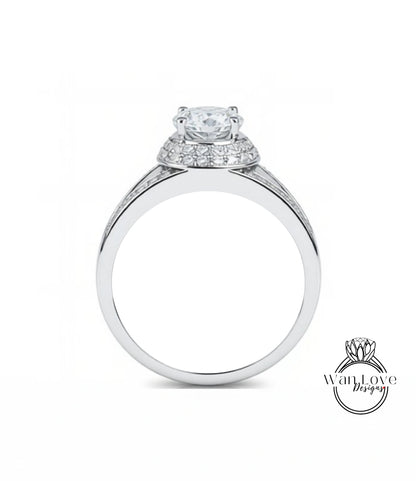 A silver engagement ring with a large central diamond surrounded by smaller diamonds on the band.
