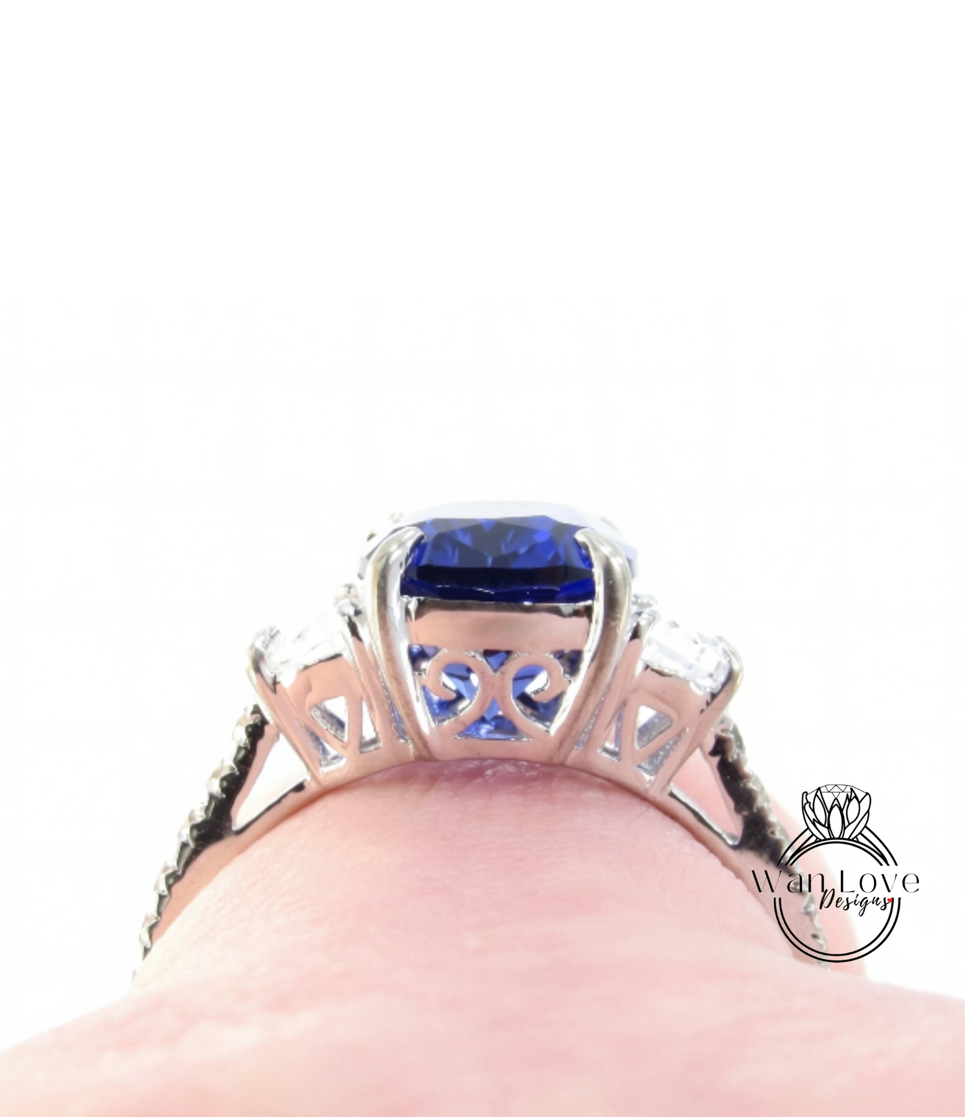 A close-up view of a silver ring with a large blue gemstone, showcasing the intricate design and craftsmanship of the piece.
