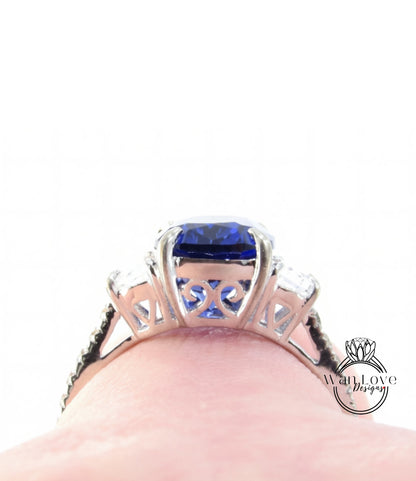 A close-up view of a silver ring with a large blue gemstone, showcasing the intricate design and craftsmanship of the piece.