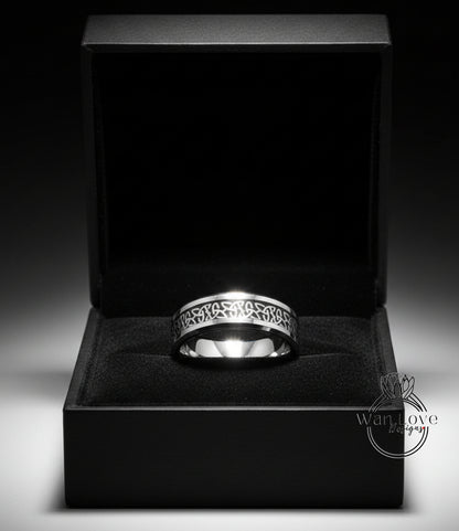 A silver ring is displayed in a black jewelry box against a dark background.