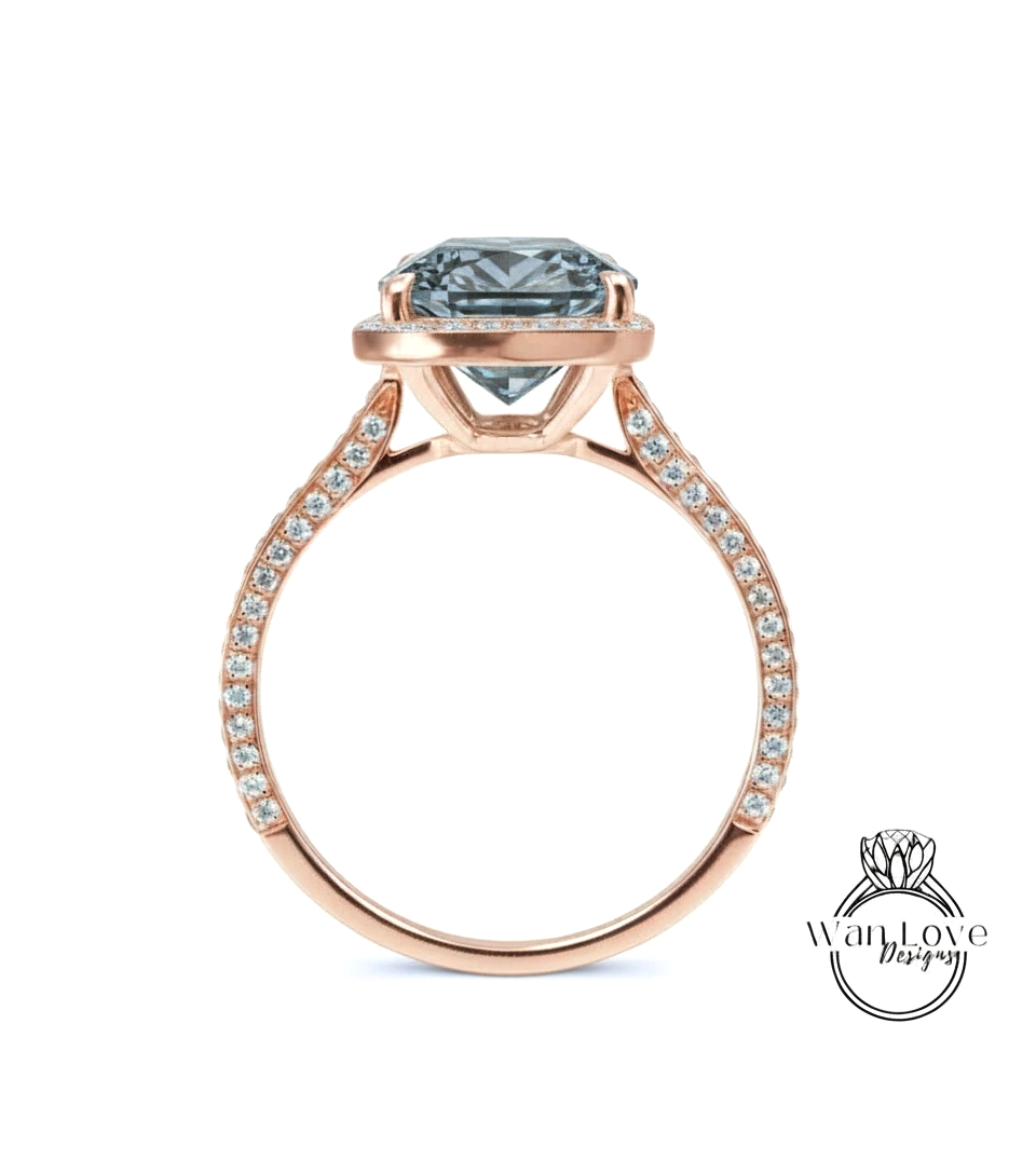 A rose gold engagement ring with a large blue gemstone set in the center, surrounded by smaller diamonds.