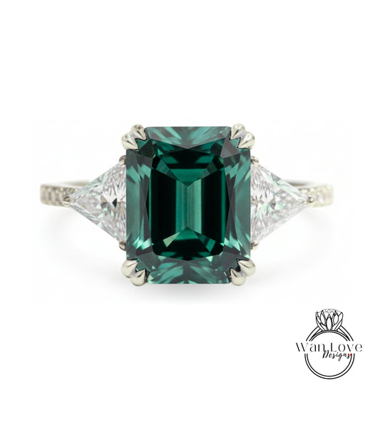 A large, green gemstone engagement ring with a diamond-encrusted band.