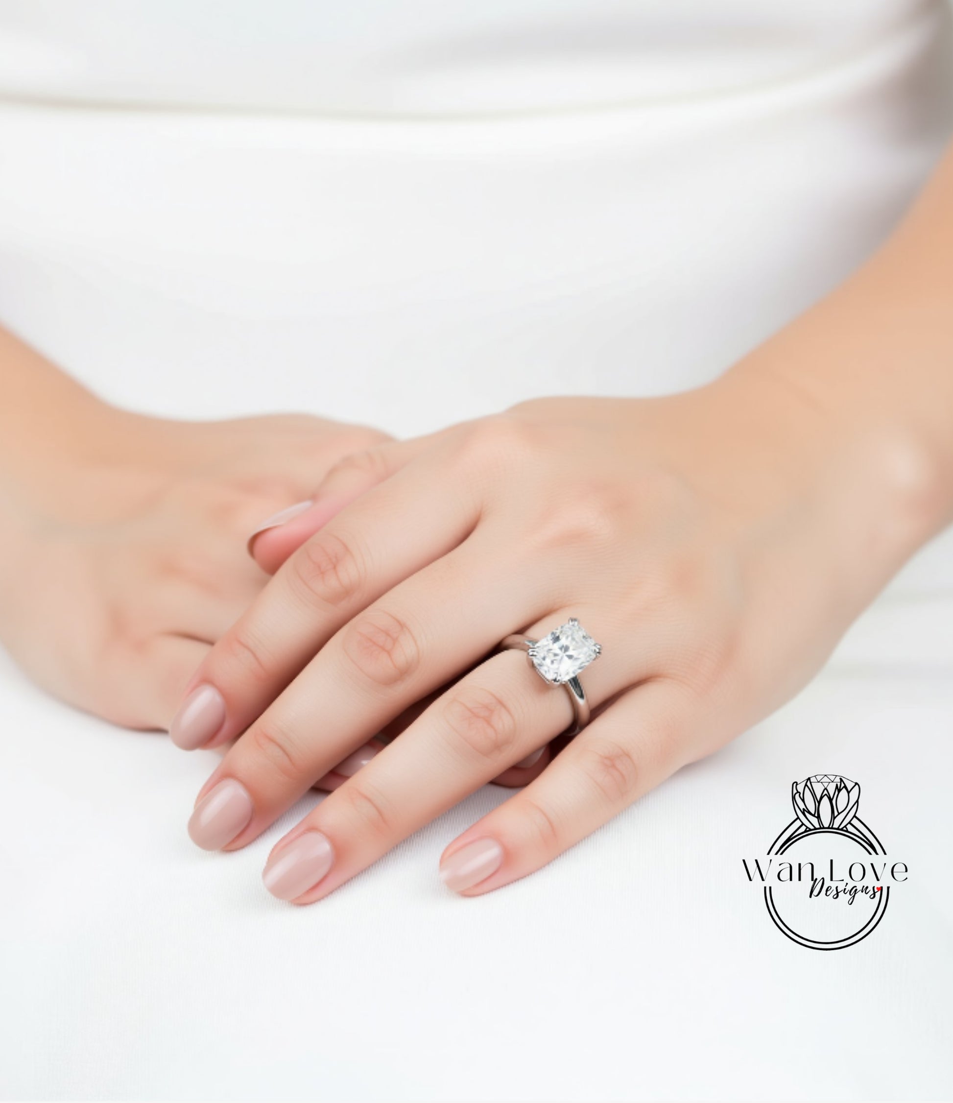 A close-up of a person's hand wearing a large diamond engagement ring.