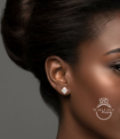 A close-up of a woman's face, focusing on her earrings and hair.