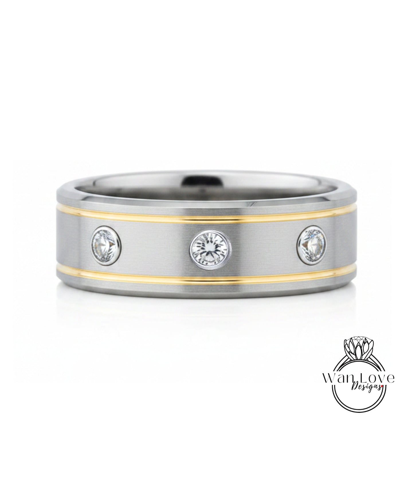 A silver and gold ring with three round diamonds set in the center.