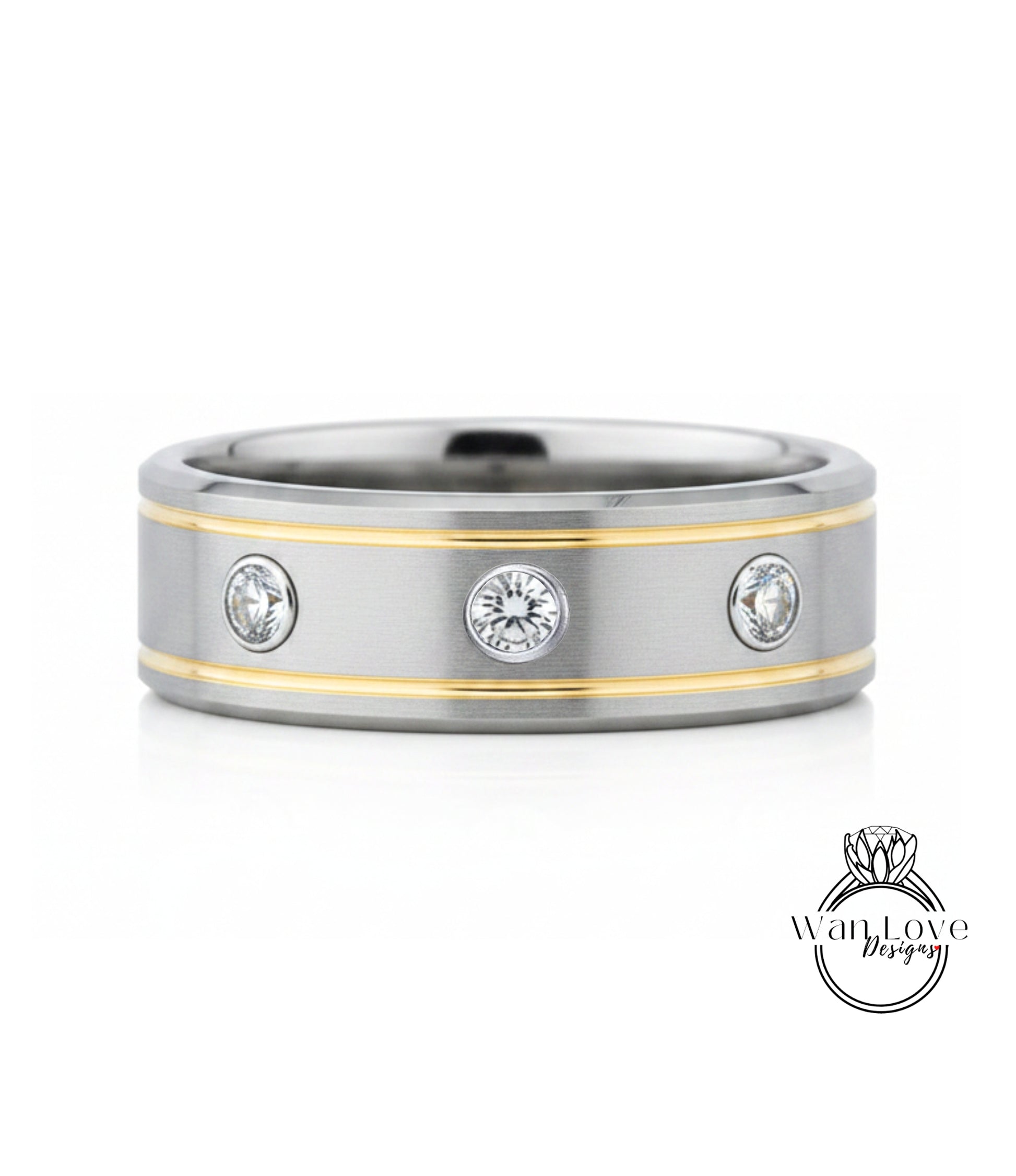 A silver and gold ring with three round diamonds set in the center.