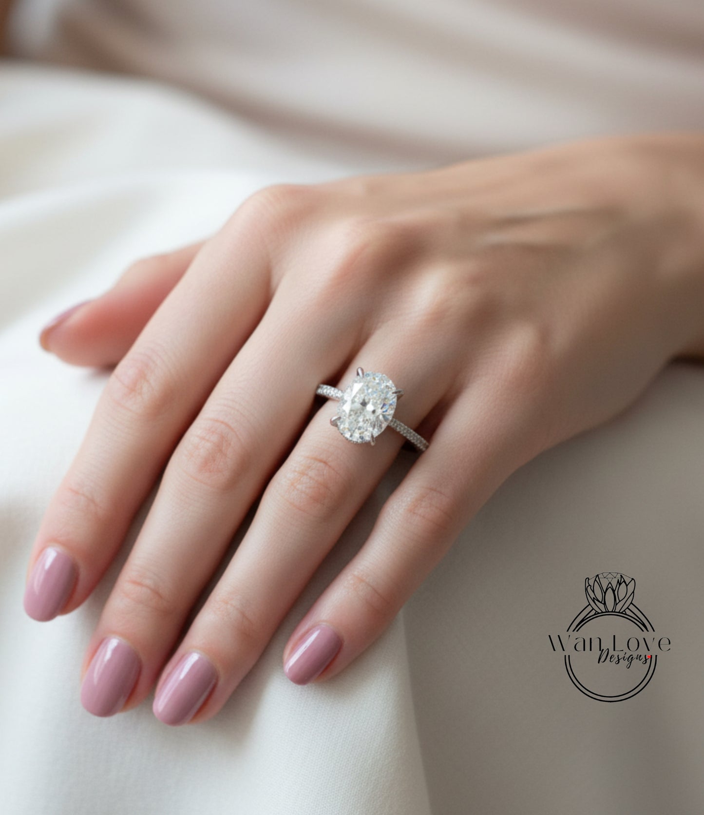 A close-up of a person's hand wearing a large diamond engagement ring.
