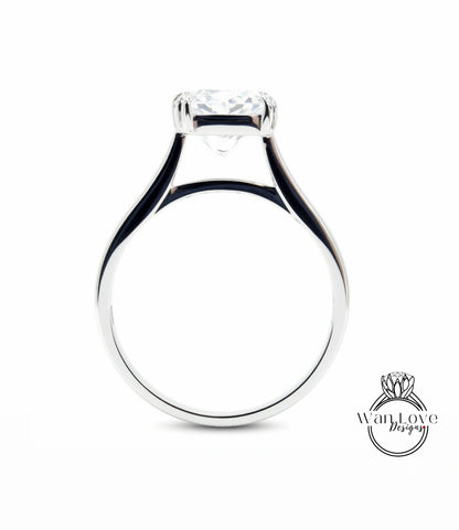 A silver engagement ring with a large central diamond.