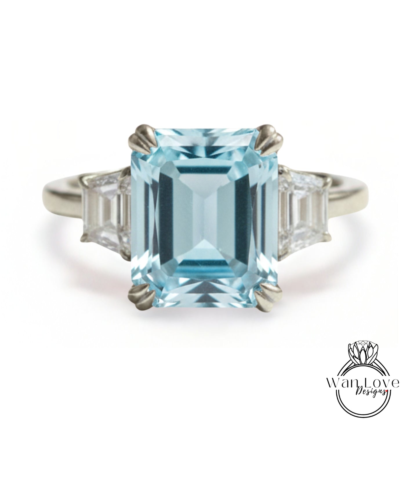 A stunning light blue gemstone engagement ring with a large central gemstone surrounded by smaller diamonds on either side.