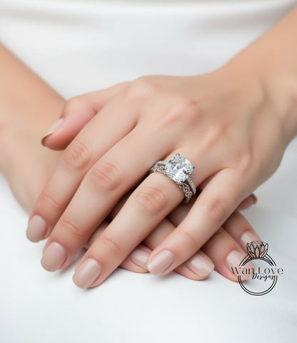 A close-up image of a person's hands wearing a large diamond engagement ring.