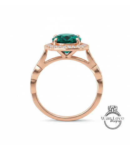 A rose gold ring with a large green gemstone set in the center, surrounded by smaller diamonds.