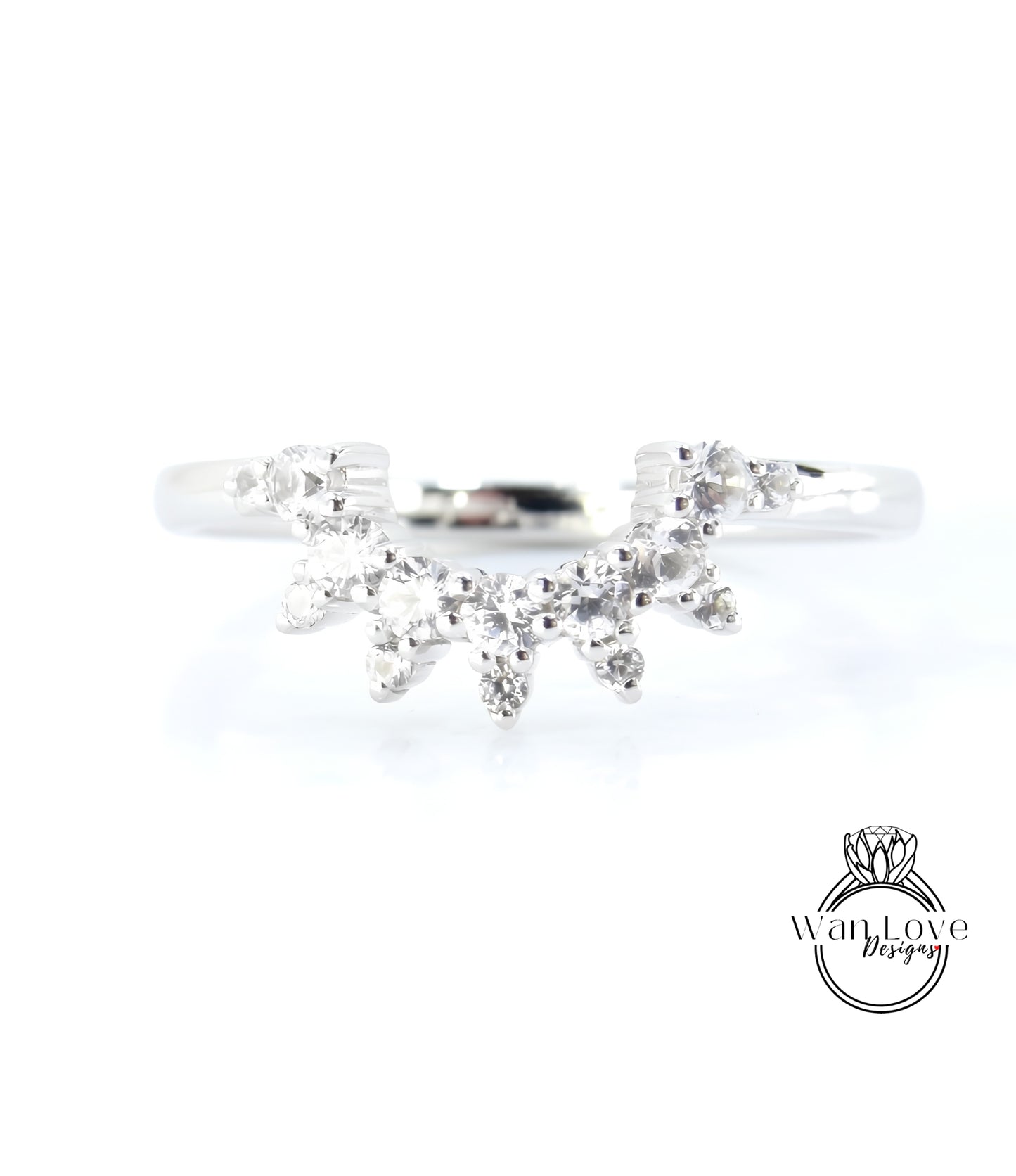 A silver ring with a large, sparkling diamond in the center, surrounded by smaller diamonds.