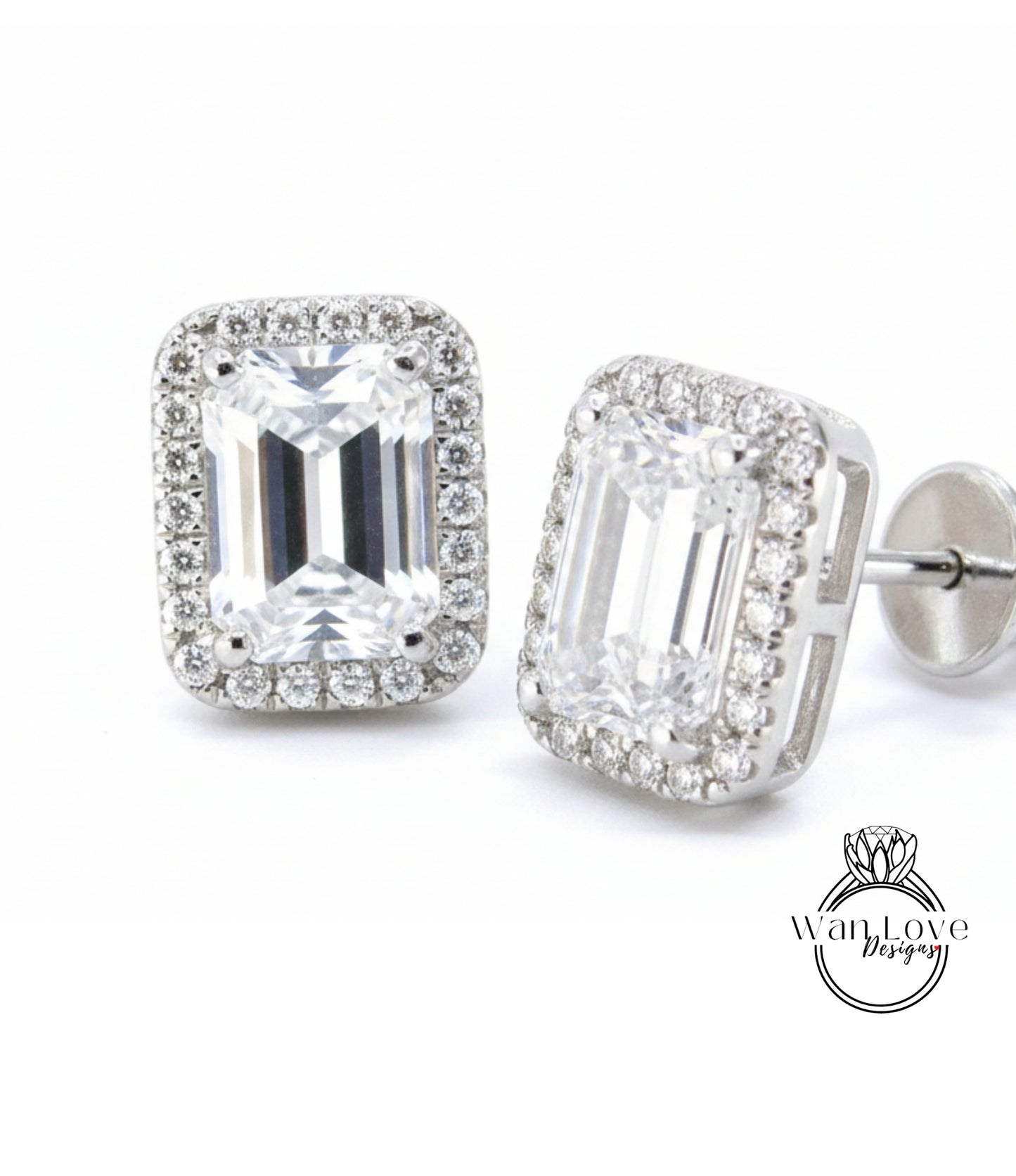 A pair of elegant earrings with large, clear gemstones set in a halo of smaller diamonds, creating a sparkling and sophisticated appearance.