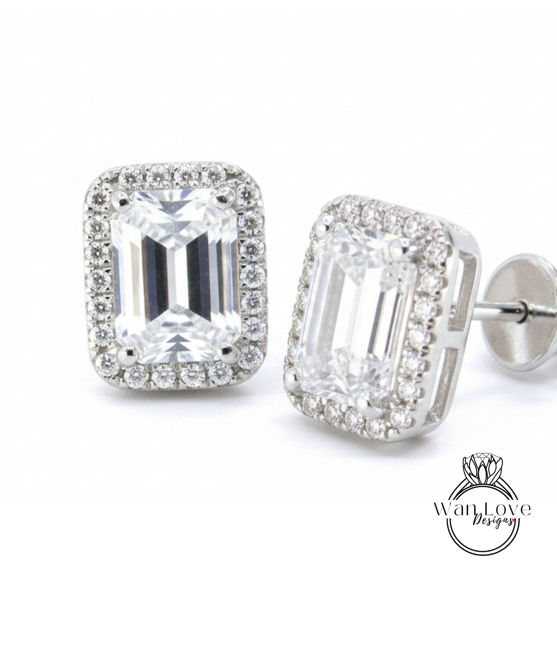 A pair of elegant earrings with large, clear gemstones set in a halo of smaller diamonds, creating a sparkling and sophisticated appearance.