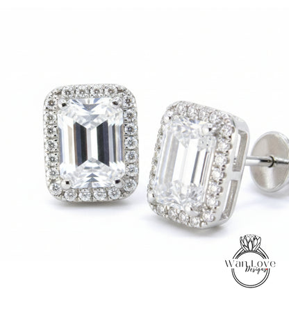 A pair of elegant earrings with large, clear gemstones set in a halo of smaller diamonds, creating a sparkling and sophisticated appearance.