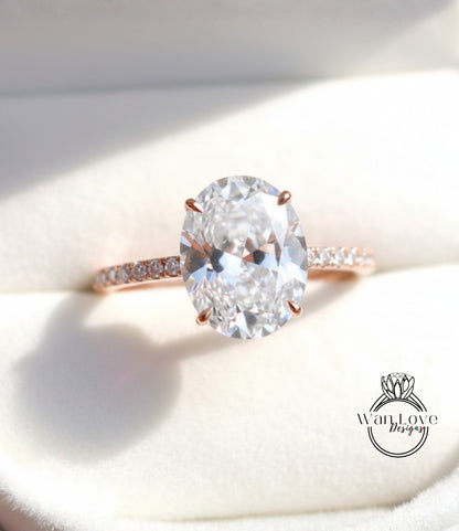 A close-up image of a diamond engagement ring with a large oval-shaped diamond set in a rose gold band.
