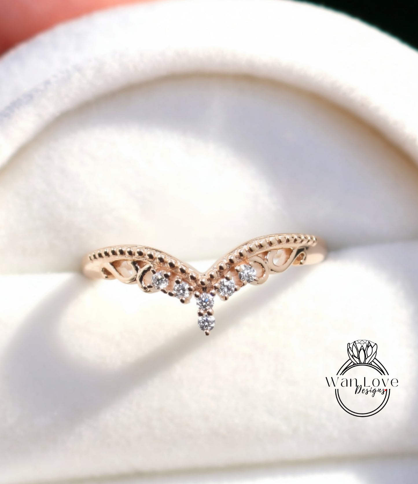 A close-up image of a gold ring with a decorative band featuring small diamonds.