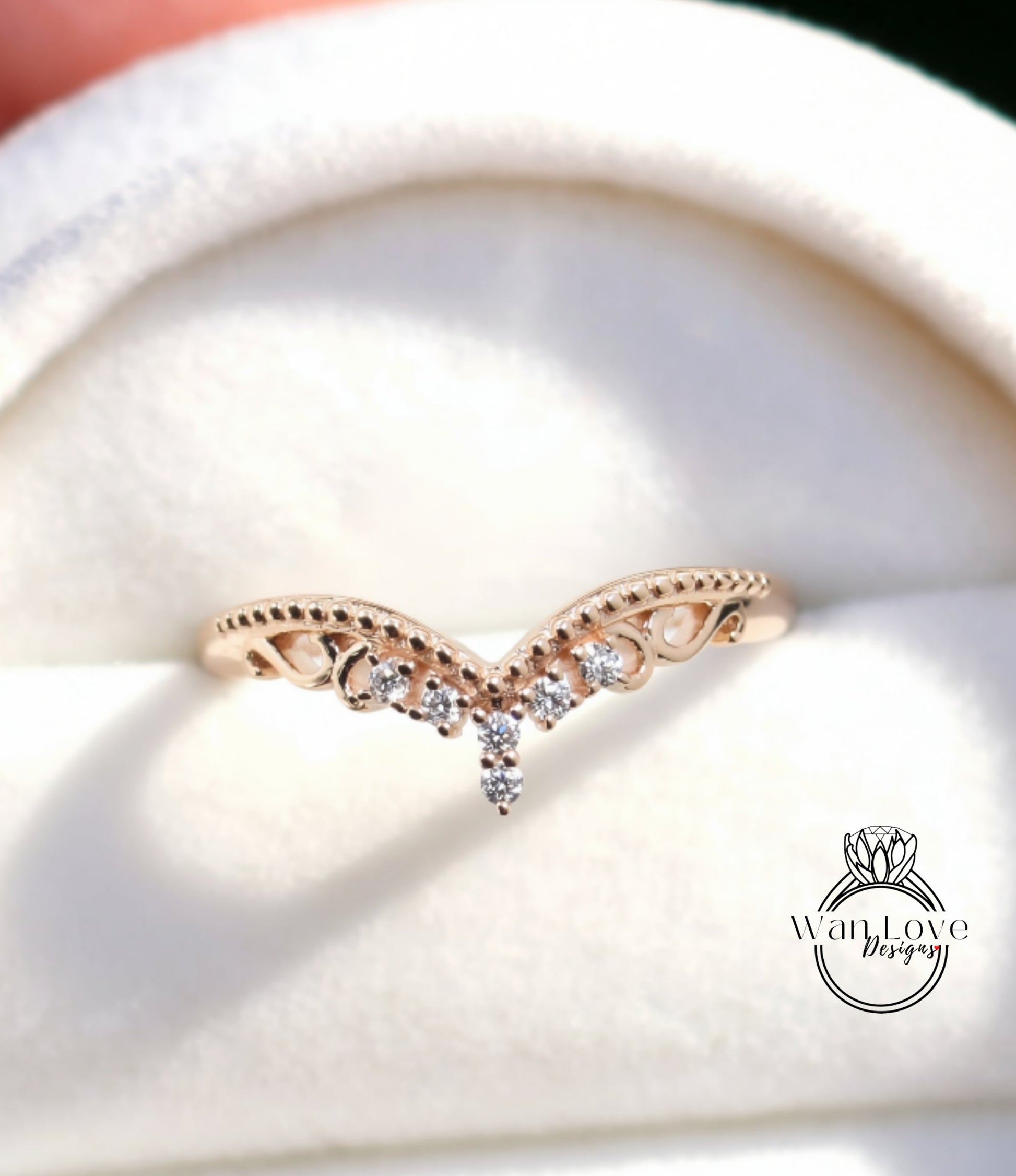 A close-up image of a gold ring with a decorative band featuring small diamonds.