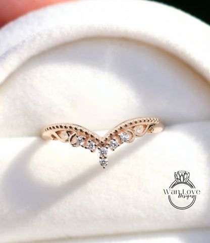 A close-up image of a gold ring with a decorative band featuring small diamonds.